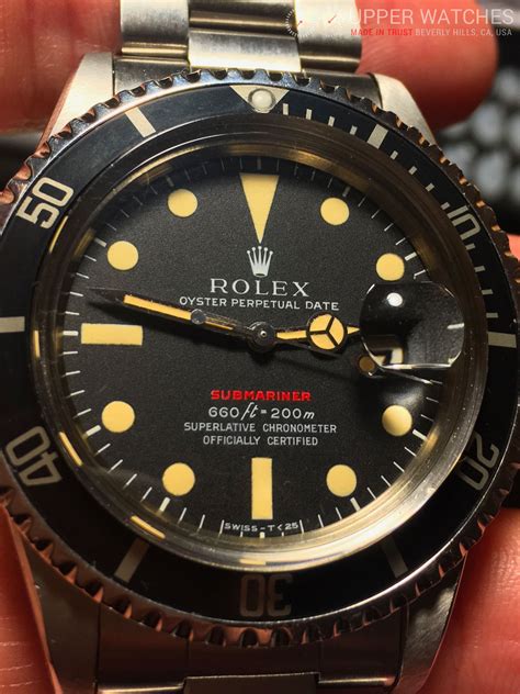 rolex submariner with red letters.